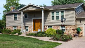 Suburban home with tan siding and brick