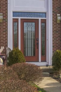 Entry door on a brick home with a lot of glass