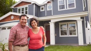 dayton energy efficient window styles on blue home behind elderly dayton homeowner couple