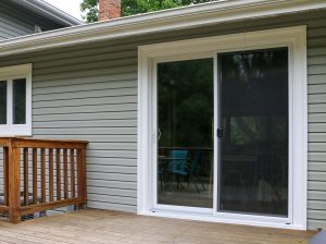 Showcase of sliding patio door with gray color siding