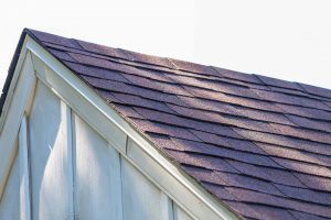 Closeup of asphalt shingles on a peaked roof