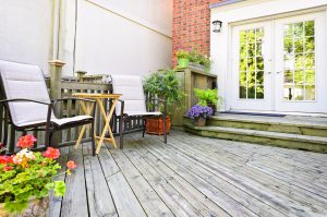 Wooden deck on house with chairs and french doors