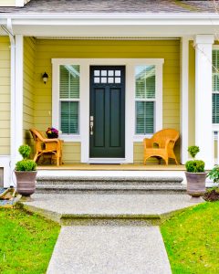 Front entrance of a yellow home.